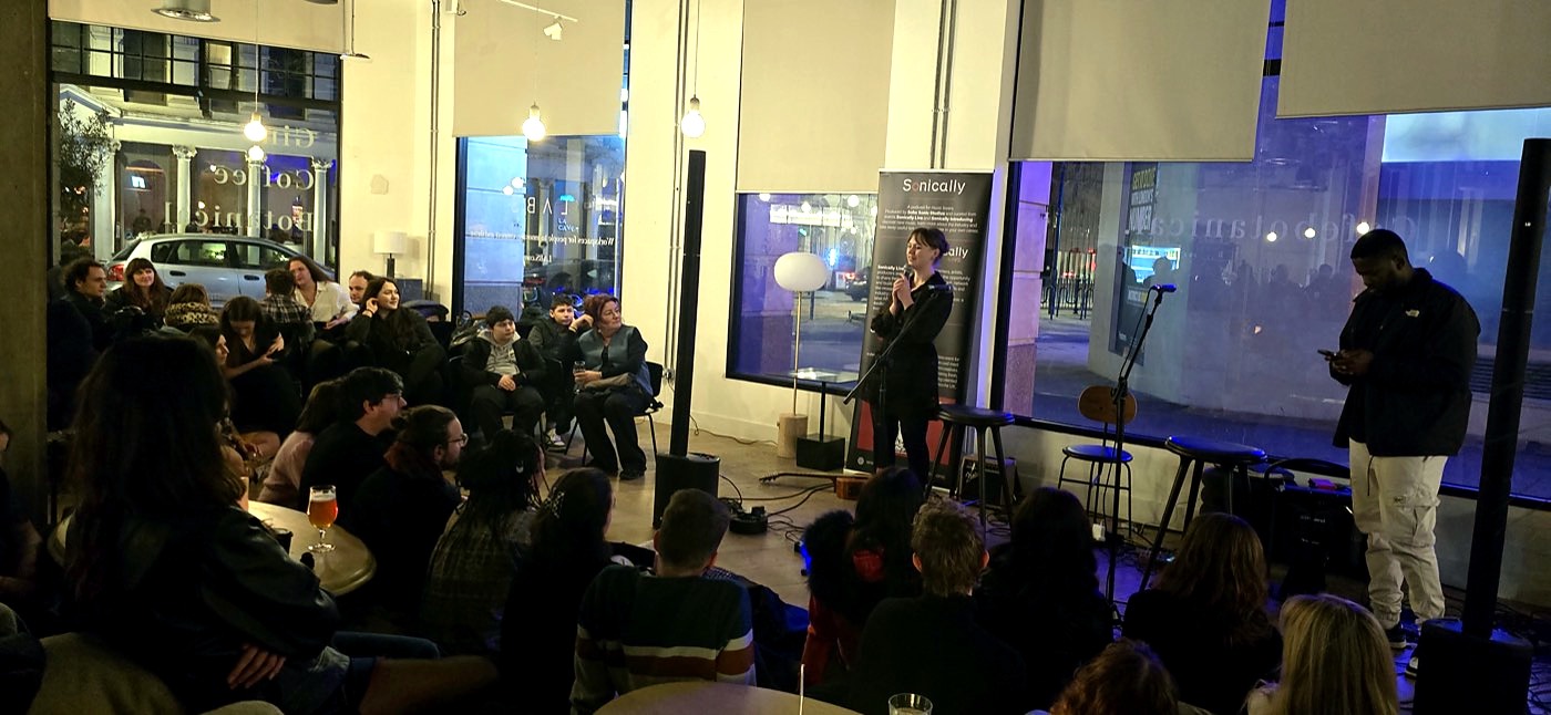 A Sonically Live evening at a street-level venue, room at capacity.